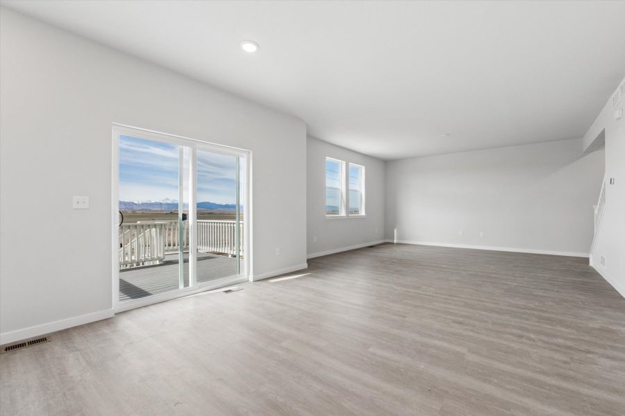 A room with a wood floor and a wood floor with a window. A room with a wood floor and a wood floor with a window.