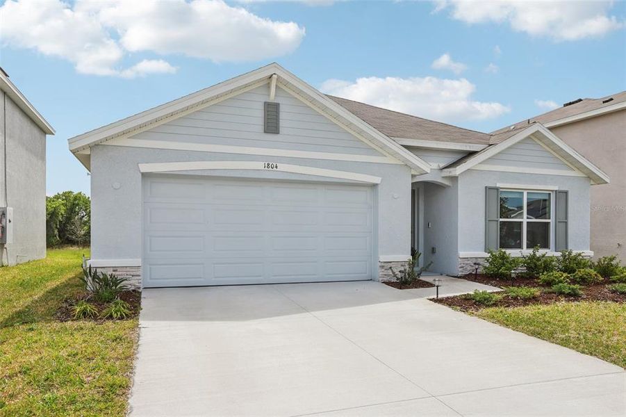 Front exterior of a new home in North Park Isle, Plant City, FL, highlighting curb appeal (Image 25).