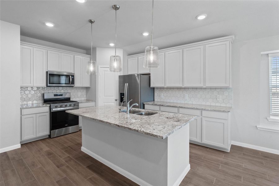 This gorgeous kitchen is an entertainer’s dream, featuring an oversized island, premium finishes, and abundant storage. Designed as the home's ultimate social hub, it offers the perfect balance of open-concept beauty and functional workspace.