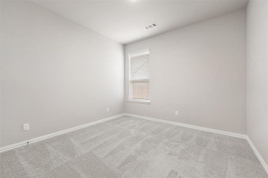 Carpeted spare room featuring baseboards Carpeted spare room featuring baseboards