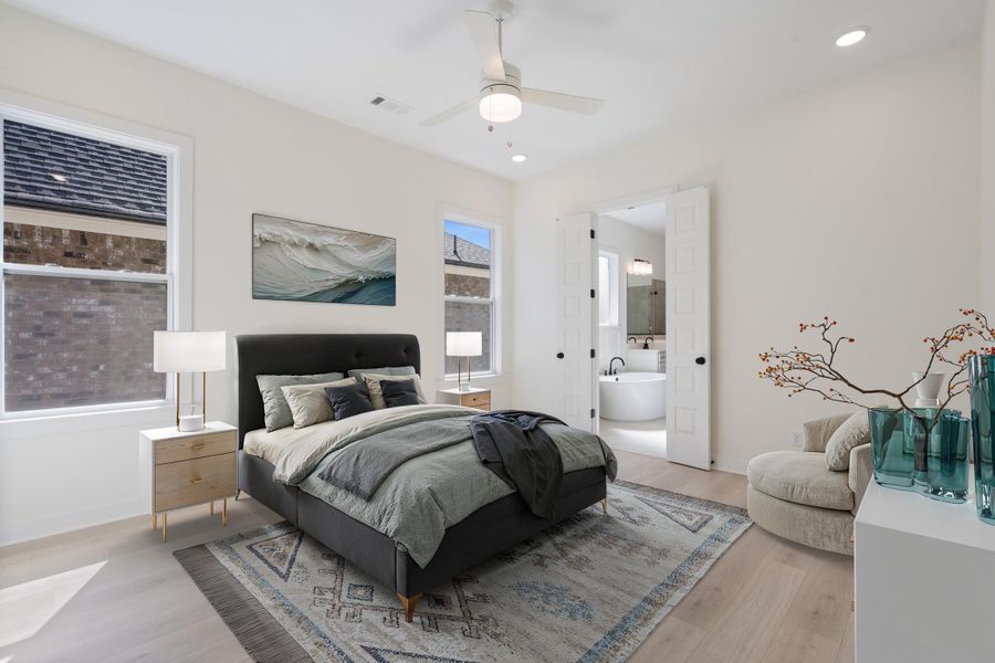 Neutral-toned room featuring wood-finish flooring, recessed lighting, a white ceiling fan with integrated light, and dual-panel interior doors Neutral-toned room featuring wood-finish flooring, recessed lighting, a white ceiling fan with integrated light, and dual-panel interior doors