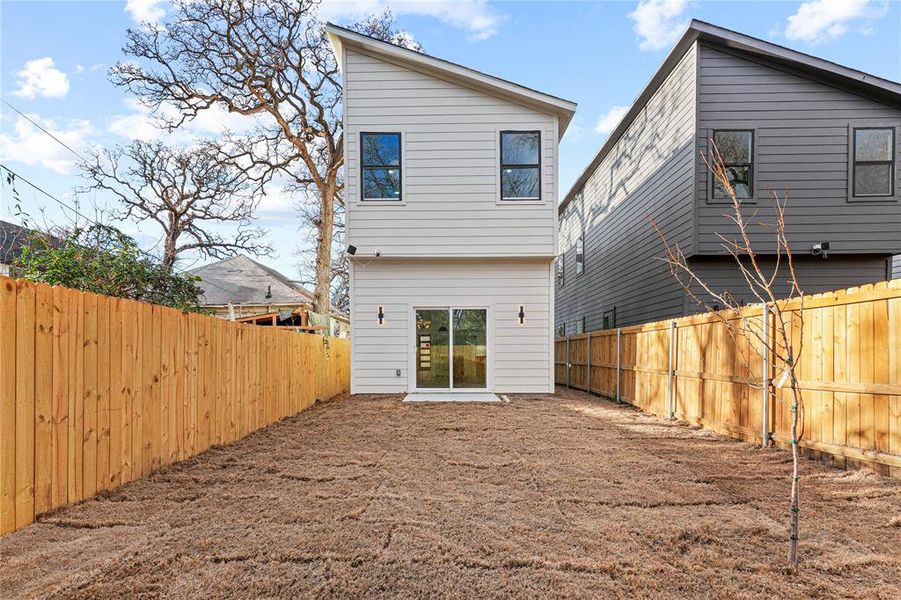 Rear view of property featuring a fenced backyard Rear view of property featuring a fenced backyard