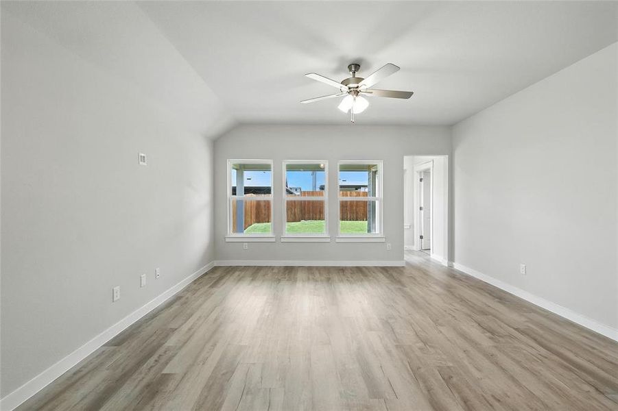 Unfurnished living room with ceiling fan and wood finished floors