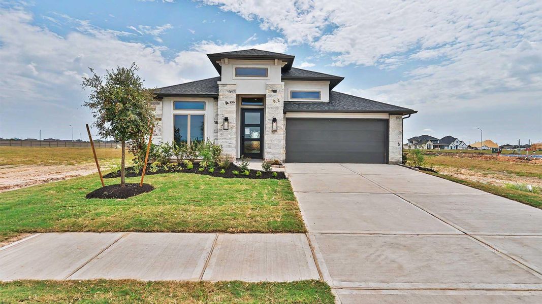 Front exterior of a new home in Revera, Richmond, TX, highlighting curb appeal (Image 2).