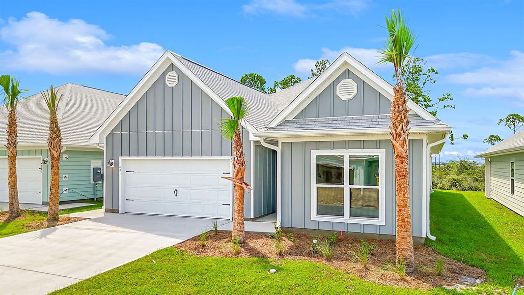 Front exterior of a new home in WindMark Beach, Port Saint Joe, FL, highlighting curb appeal (Image 22).