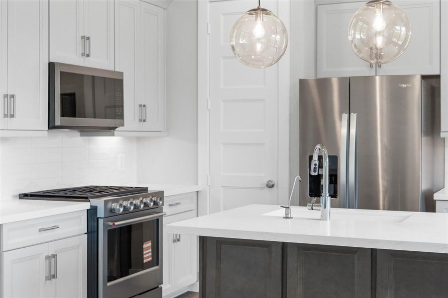 A chef-ready suite of premium, modern stainless steel appliances anchors this stunning contemporary kitchen. A chef-ready suite of premium, modern stainless steel appliances anchors this stunning contemporary kitchen.