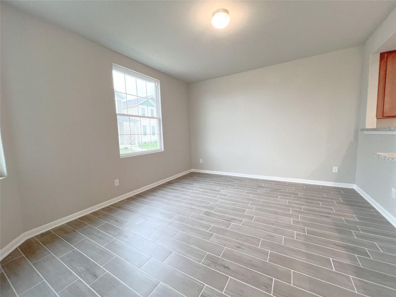 A versatile interior space featuring modern flooring and a sun-filled window, perfect for various living arrangements. A versatile interior space featuring modern flooring and a sun-filled window, perfect for various living arrangements.