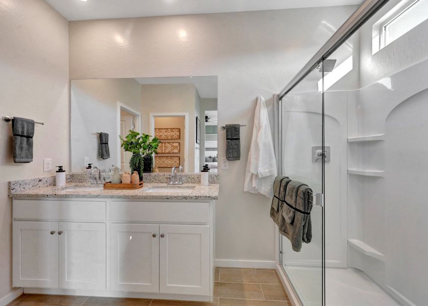 A bathroom with a shower and sink.