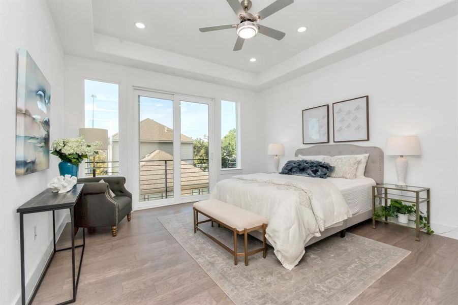 Primary bedroom with tons of natural light flooding in.