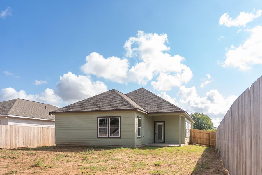 Rear view of property with a patio area and a fenced backyard