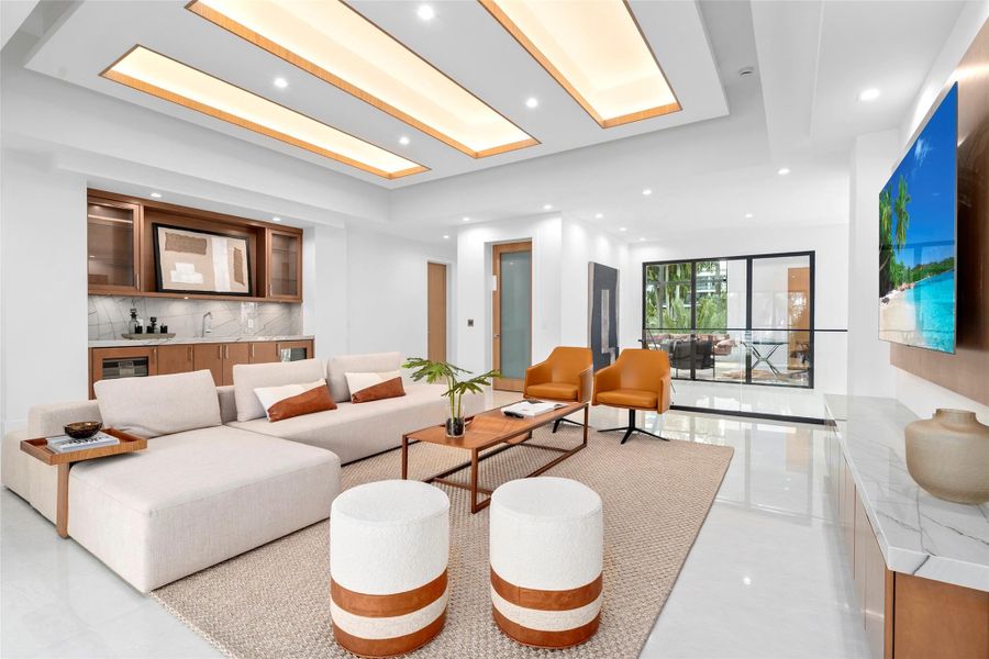 The home features a concierge lounge complete with a wet bar and wine fridge