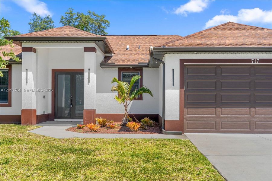 Front exterior of a new home in , Lehigh Acres, FL, highlighting curb appeal (Image 21). Front exterior of a new home in , Lehigh Acres, FL, highlighting curb appeal (Image 21).
