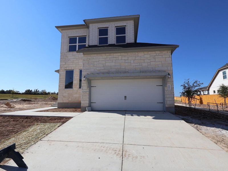 Front exterior of a new home in Cedar Brook, Leander, TX, highlighting curb appeal (Image 4).
