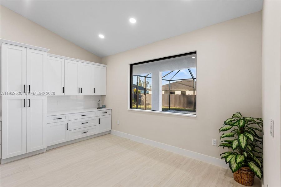 BUILT-IN CUSTOM WHITE CABINETRY provides ADDED STORAGE & CLEAN, UPSCALE LOOK.