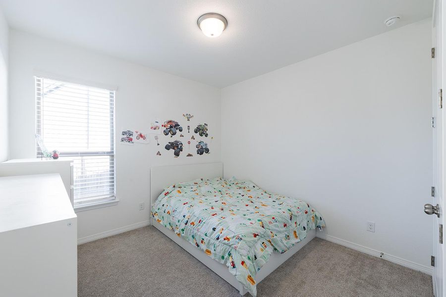 Bedroom with carpet and baseboards