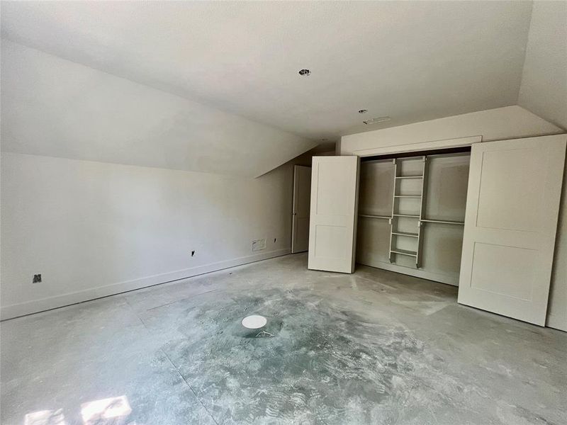 Additional living space featuring lofted ceiling