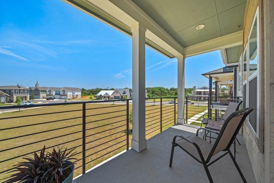 An elevated perspective offers expansive neighborhood views from this covered concrete balcony. An elevated perspective offers expansive neighborhood views from this covered concrete balcony.