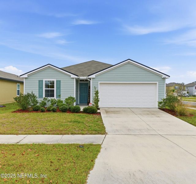 Front exterior of a new home in Cross Creek Express, Green Cove Springs, FL, highlighting curb appeal (Image 1). Front exterior of a new home in Cross Creek Express, Green Cove Springs, FL, highlighting curb appeal (Image 1).