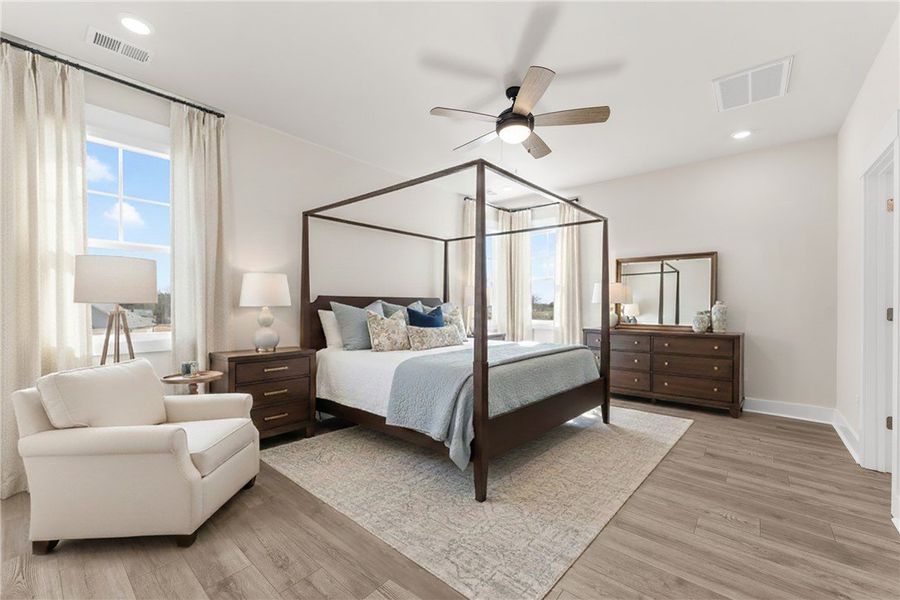 This airy bedroom offers ample light and comfortab