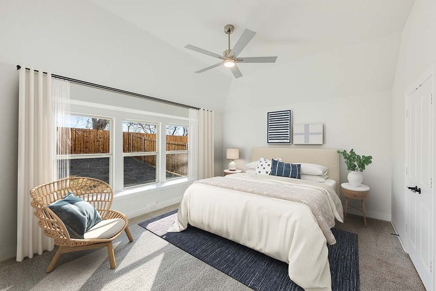 Bedroom with vaulted ceiling, ceiling fan, large windows, and neutral carpet flooring