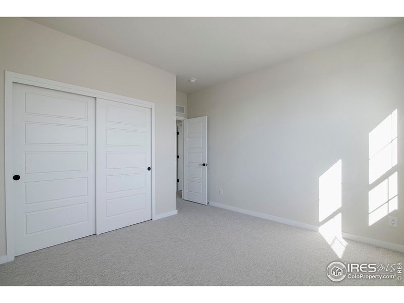 Upper level Bedroom 3 with large windows and closets