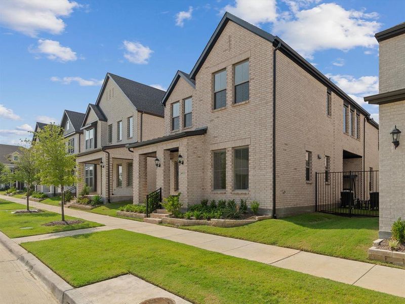 Front exterior of a new home in Village on Main Street, Frisco, TX, highlighting curb appeal (Image 24).