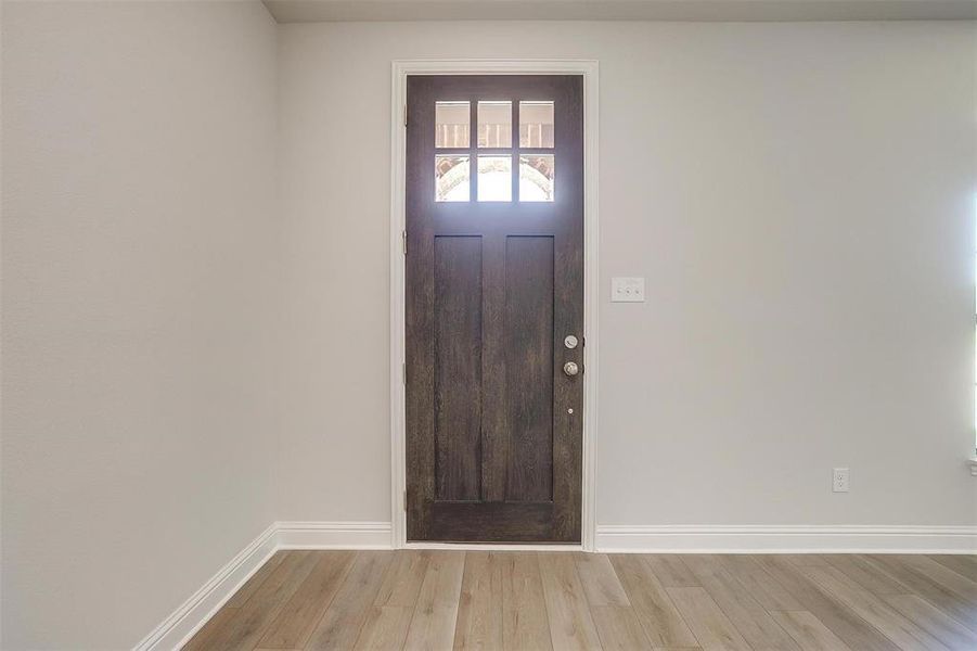 Entryway with light wood finished floors and baseboards Entryway with light wood finished floors and baseboards