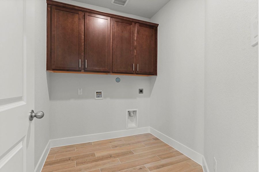 The Utility Room offers both function and style—complete with upper cabinetry for storage, space for a washer and dryer, and durable flooring that makes daily chores easier to manage. The Utility Room offers both function and style—complete with upper cabinetry for storage, space for a washer and dryer, and durable flooring that makes daily chores easier to manage.