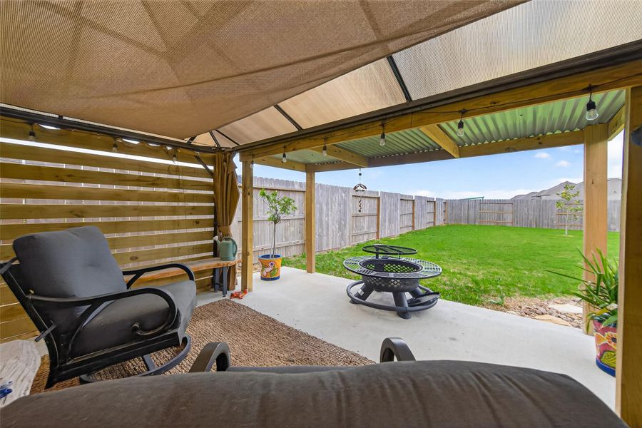 Shaded backyard structure creating an inviting outdoor living area