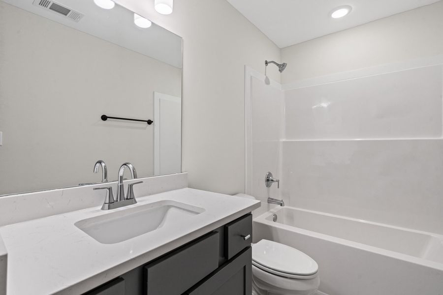 Full bath featuring vanity and bathing tub / shower combination Full bath featuring vanity and bathing tub / shower combination