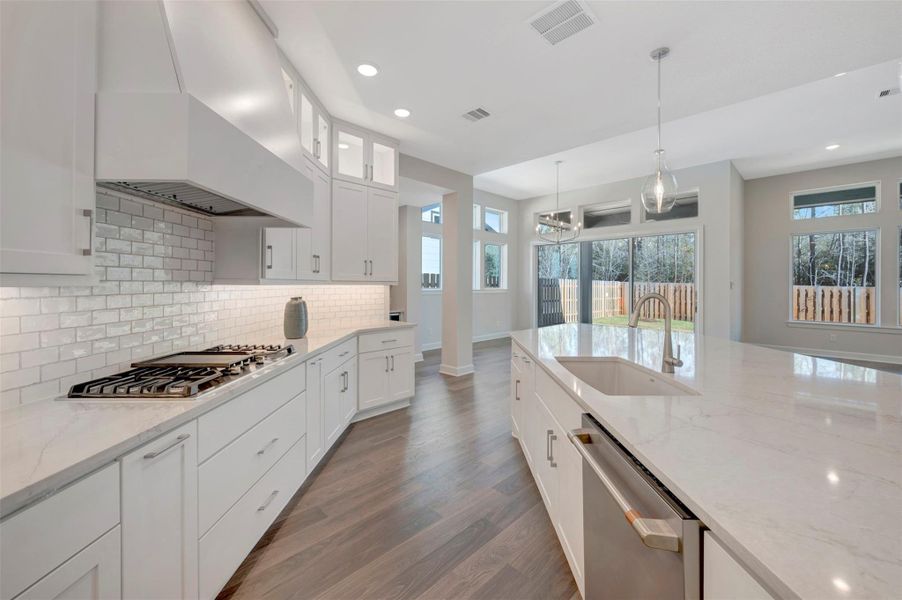 GE Cafe appliances are a compliment to this Kitchen. Plus pull out spice racks, double trash drawer, Blanco oversized Kitchen sink +++!