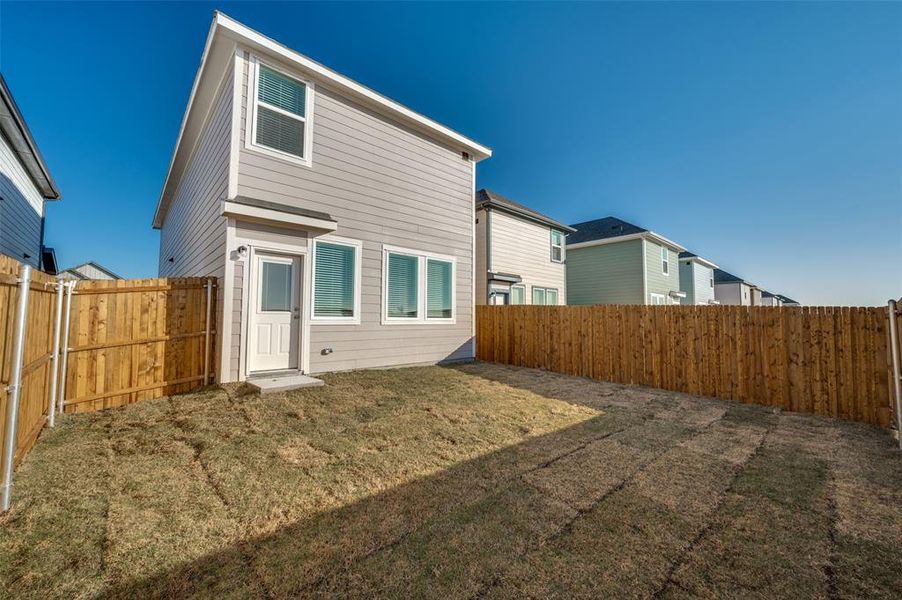 Rear view of property featuring a yard