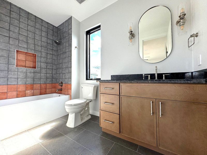 Full bath with vanity, shower / bathing tub combination, toilet, and tile patterned flooring