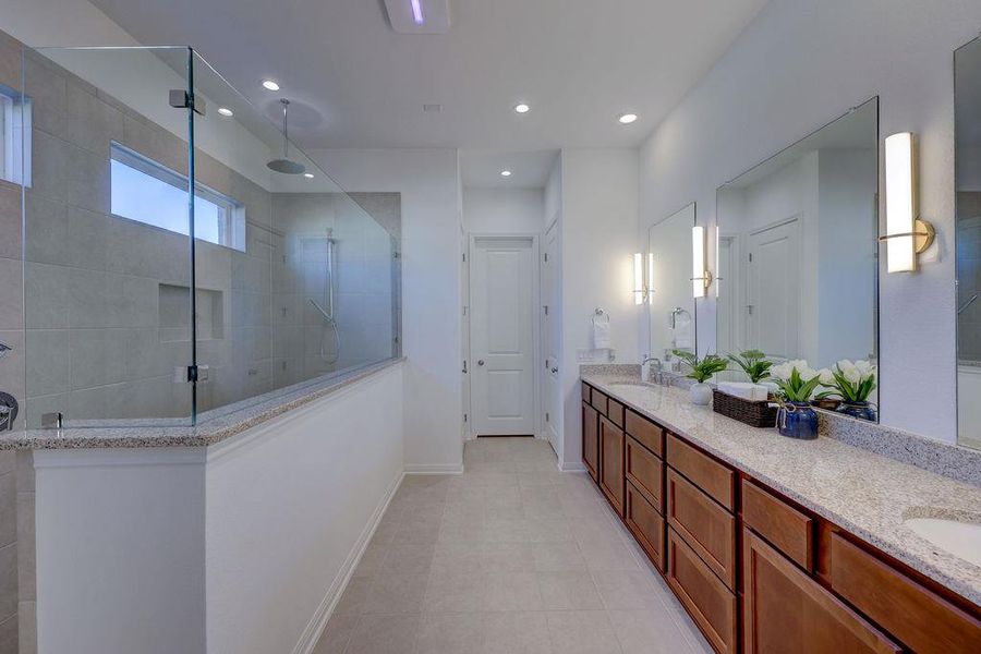 Primary Full bathroom with double vanity, a walk in shower, and recessed lighting