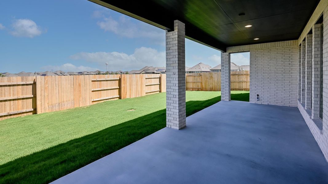 Fenced backyard featuring a patio and a residential view