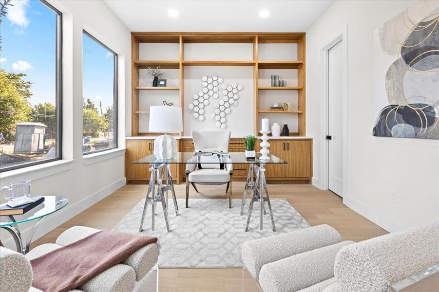 Office space with light hardwood / wood-style flooring