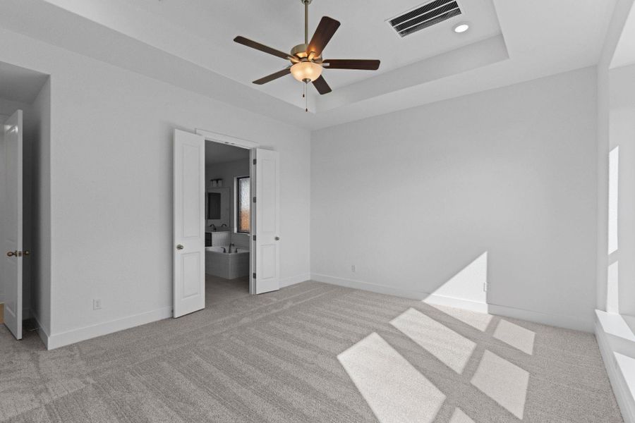 Primary Bedroom with elevated ceiling