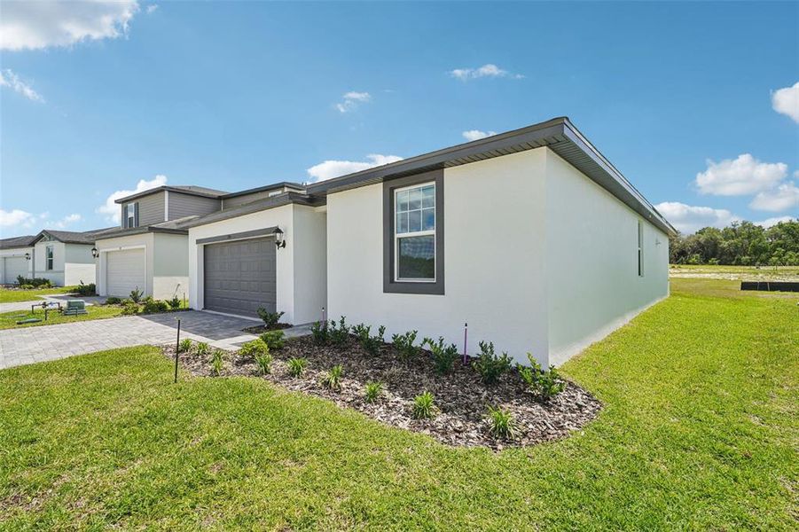 Front exterior of a new home in The Reserve at Hammock Oaks - Signature Series, Lady Lake, FL, highlighting curb appeal (Image 18).