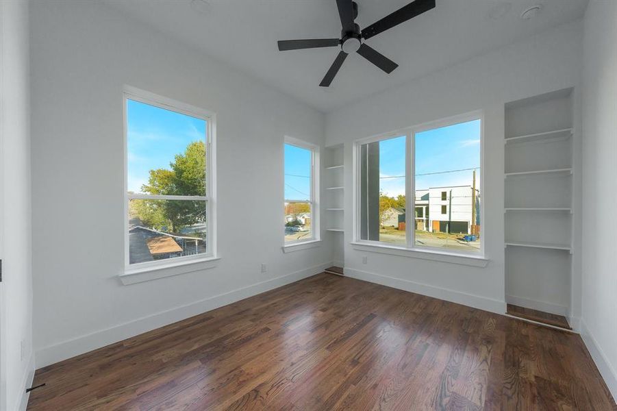 Upstairs bedroom, with built in shelving, ceiling fan and hardwood floors. Upstairs bedroom, with built in shelving, ceiling fan and hardwood floors.