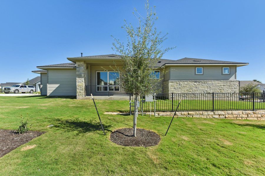 Back of house with stone siding