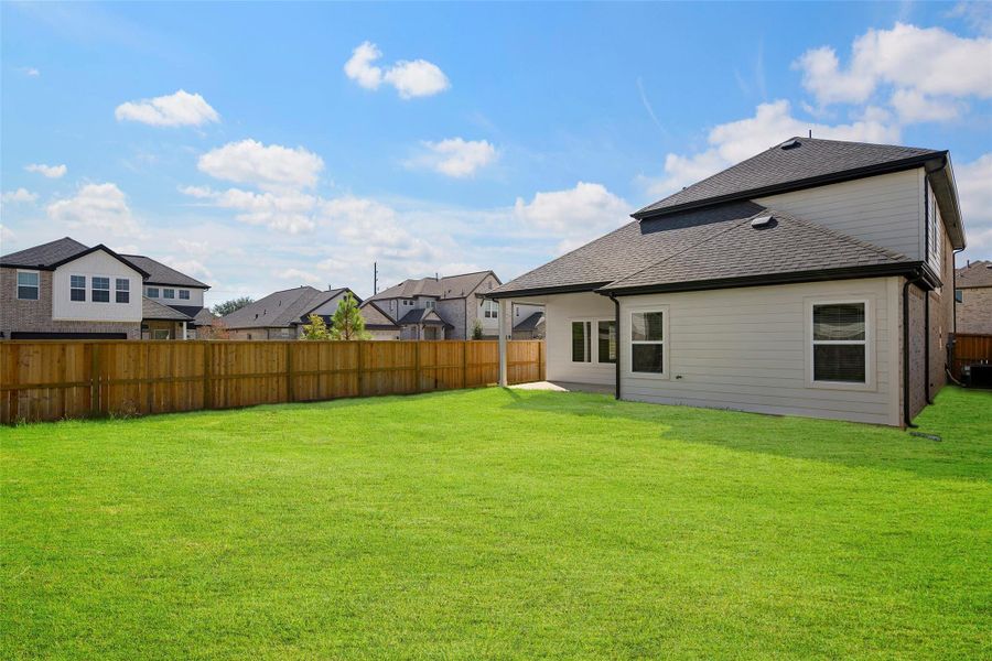 Large backyard offering room for outdoor dining, play, or future upgrades.