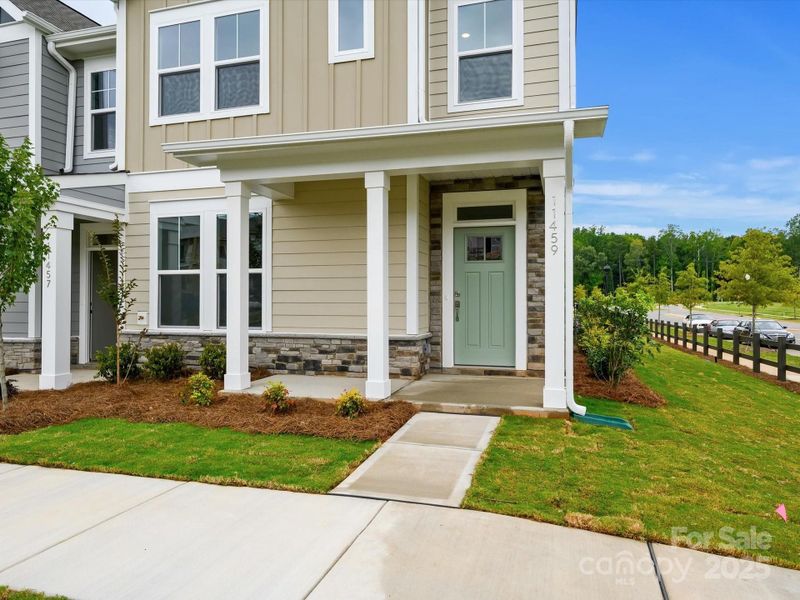 Front exterior of a new home in North Creek Village - Townhomes, Huntersville, NC, highlighting curb appeal (Image 16). Front exterior of a new home in North Creek Village - Townhomes, Huntersville, NC, highlighting curb appeal (Image 16).