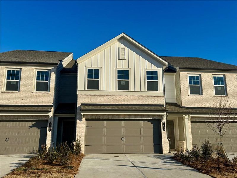 Front exterior of a new home in Eastlyn Crossing, Flowery Branch, GA, highlighting curb appeal (Image 2). Front exterior of a new home in Eastlyn Crossing, Flowery Branch, GA, highlighting curb appeal (Image 2).