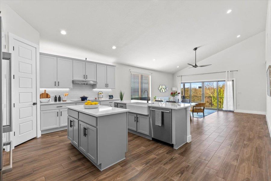 Kitchen featuring a center island, recessed lighting, tasteful backsplash, gray cabinetry, and a ceiling fan