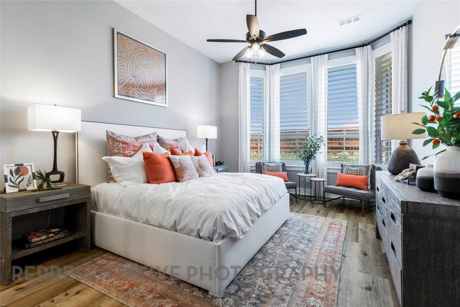 Bedroom with hardwood / wood-style floors, floor to ceiling windows, and ceiling fan Bedroom with hardwood / wood-style floors, floor to ceiling windows, and ceiling fan