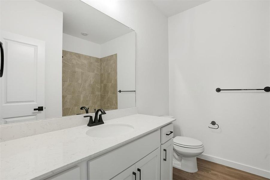 Full bathroom with vanity, dark wood finished floors, and a shower Full bathroom with vanity, dark wood finished floors, and a shower