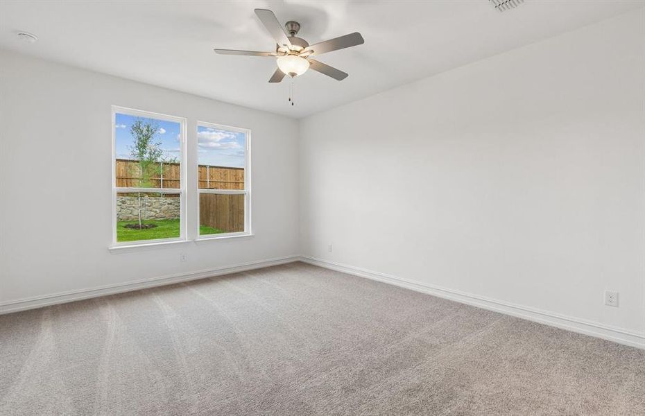 Spacious primary bedroom with large windows Spacious primary bedroom with large windows