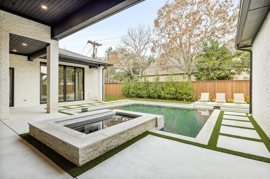 The pool and spa sit at the center of the backyard, creating a space that works just as well for quiet afternoons as it does for hosting friends