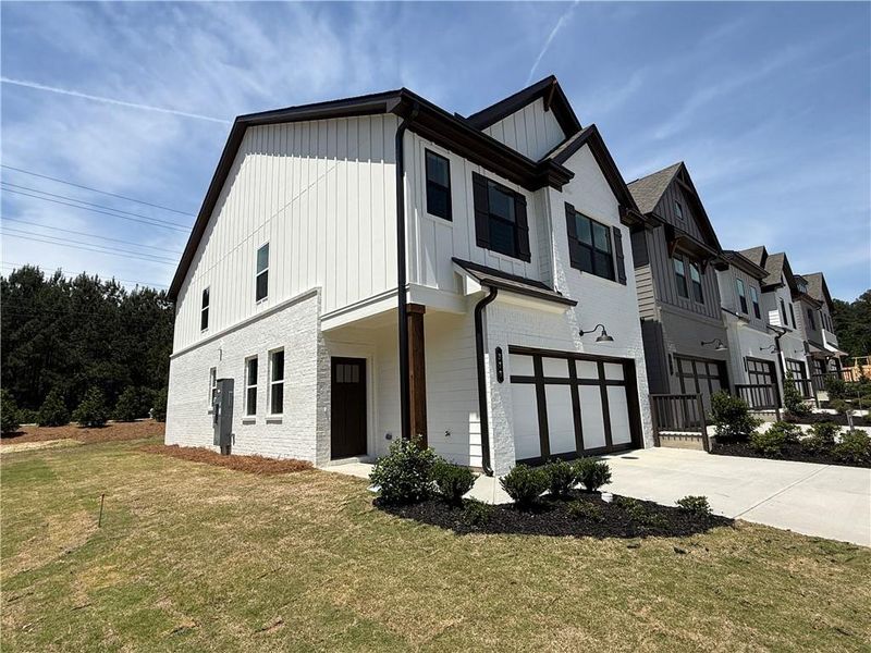 Front exterior of a new home in The Towns at Auburn Station East, Auburn, GA, highlighting curb appeal (Image 2). Front exterior of a new home in The Towns at Auburn Station East, Auburn, GA, highlighting curb appeal (Image 2).