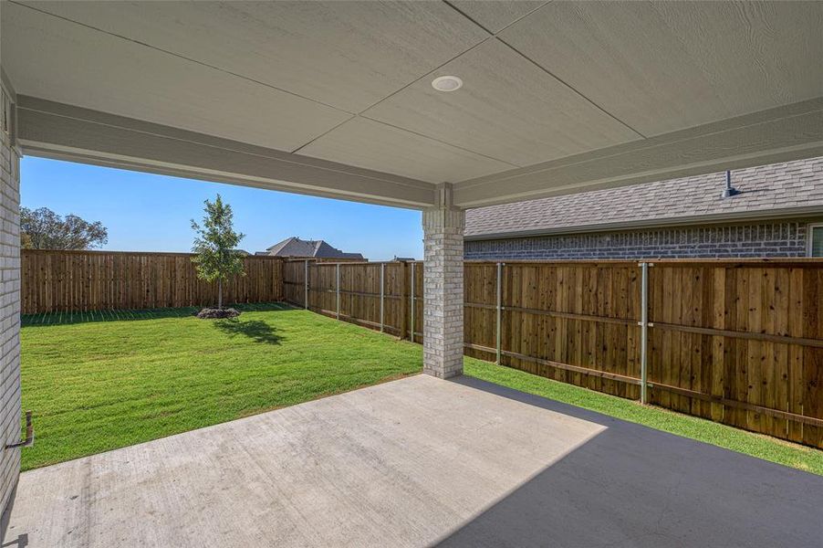 Fenced backyard with a patio